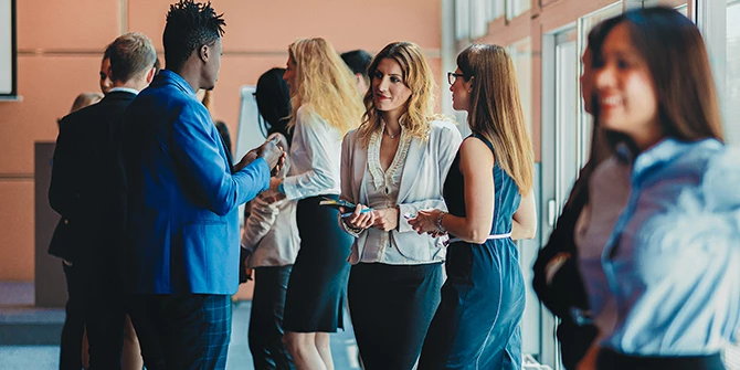 Conference attendees networking in a loby